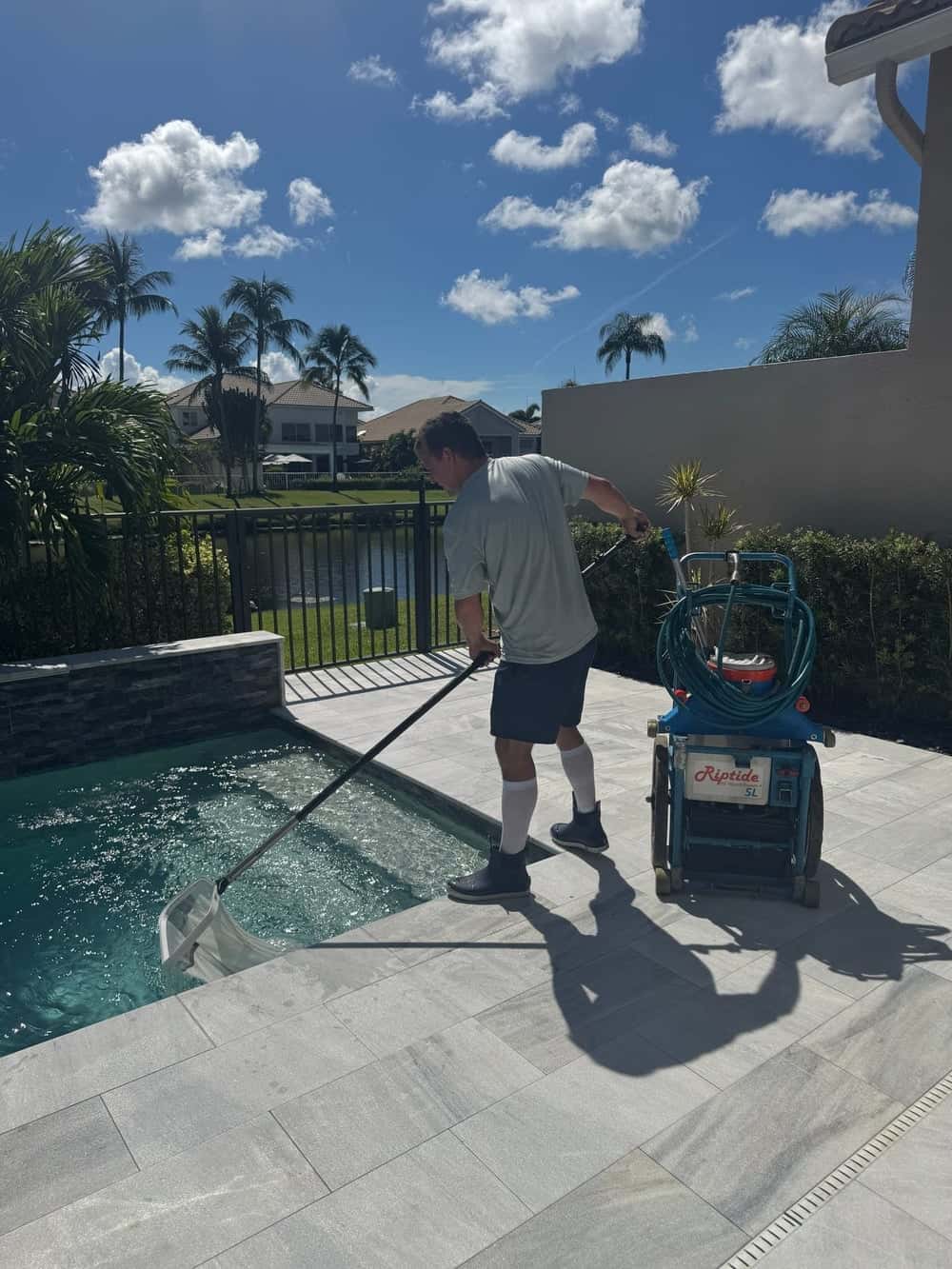 Technician vacuuming recovered pool