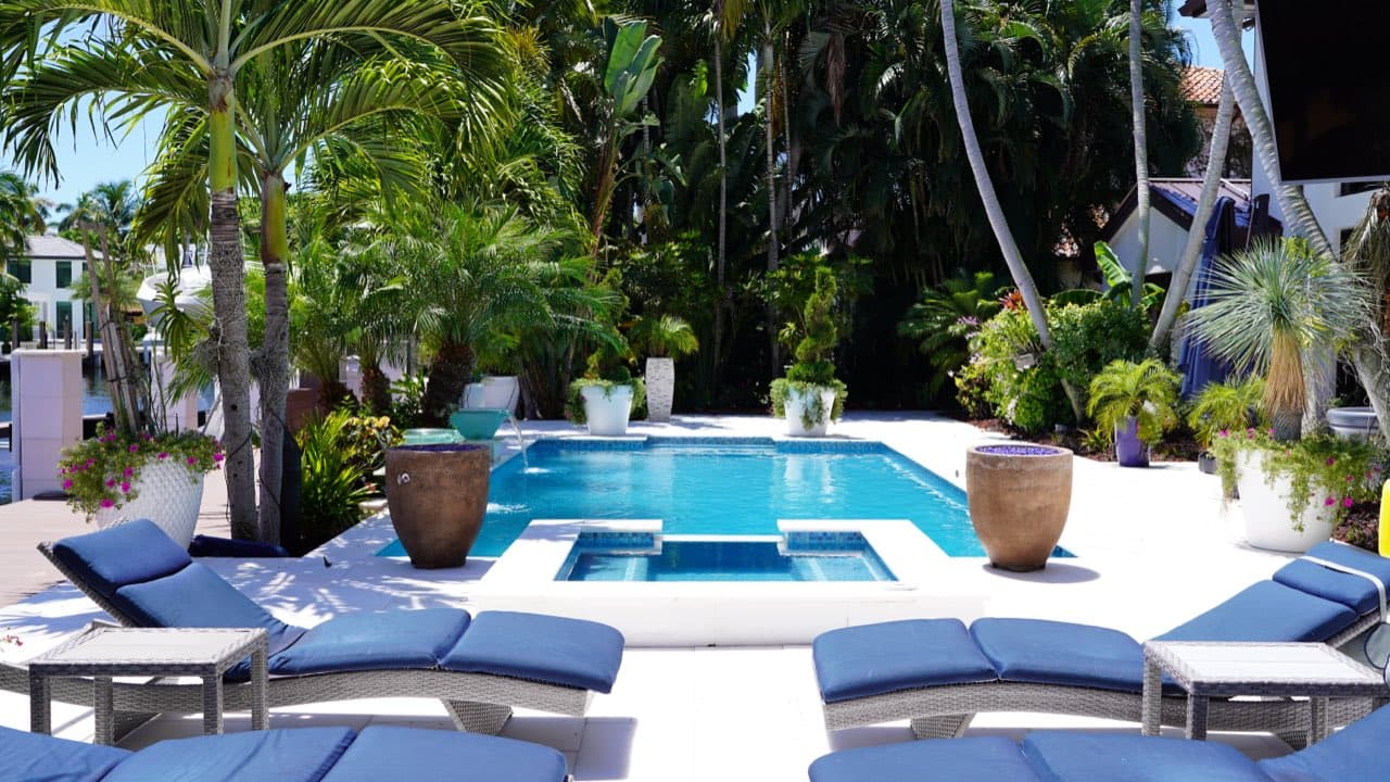 Crystal-clear resurfaced residential pool in South Florida after a renovation