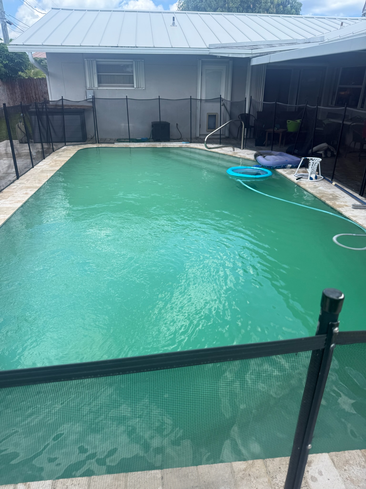 Cloudy pool water in a South Florida residential pool — milky cloud throughout with chemistry imbalance, the signature of cause #1