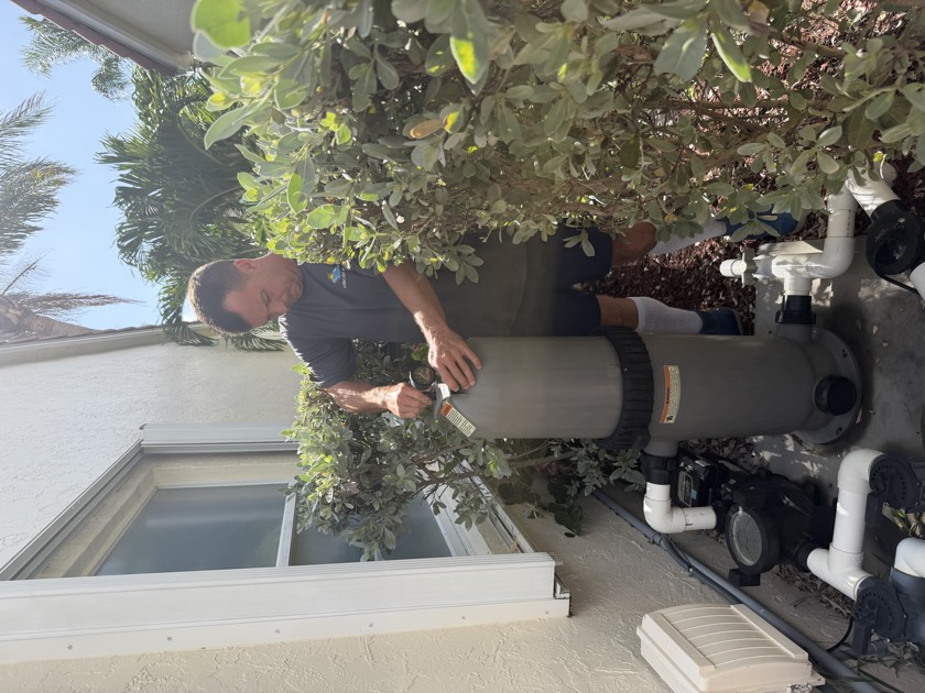 Florida's Best Pools technician inspecting the pool filter and equipment pad during a pre-purchase pool inspection in South Florida — logging filter pressure baseline and checking media condition that a standard home inspection skips
