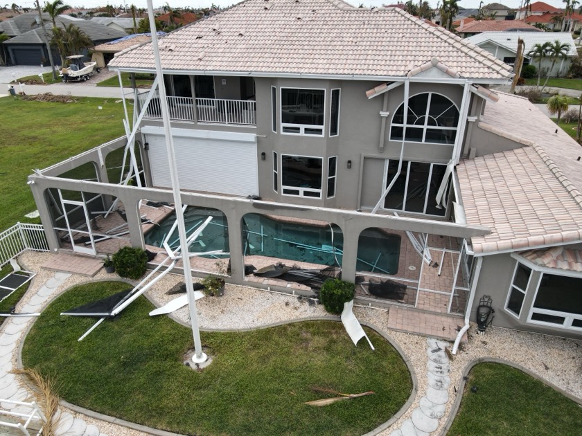 Close-up of hurricane damage to a South Florida pool and deck, the kind of loss documented for an insurance claim