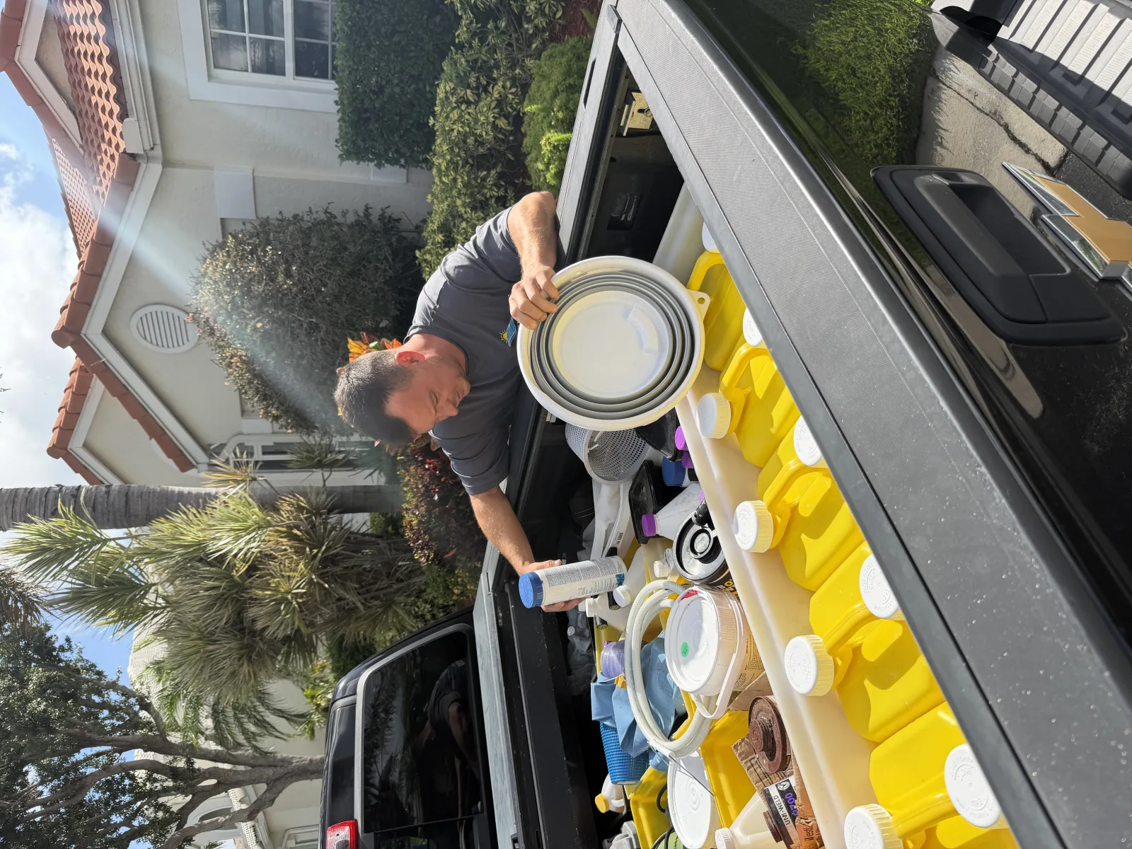 Florida's Best Pools service truck stocked with calibrated reagent kits, brushes, chemicals, and tools — the standard kit a legitimate Delray Beach pool service tech carries to every visit