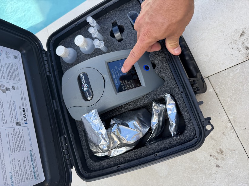Florida's Best Pools technician running a calibrated reagent water test for cyanuric acid on a South Florida pool — a Taylor K-2006 turbidity test, the only accurate way to read CYA that test strips cannot do